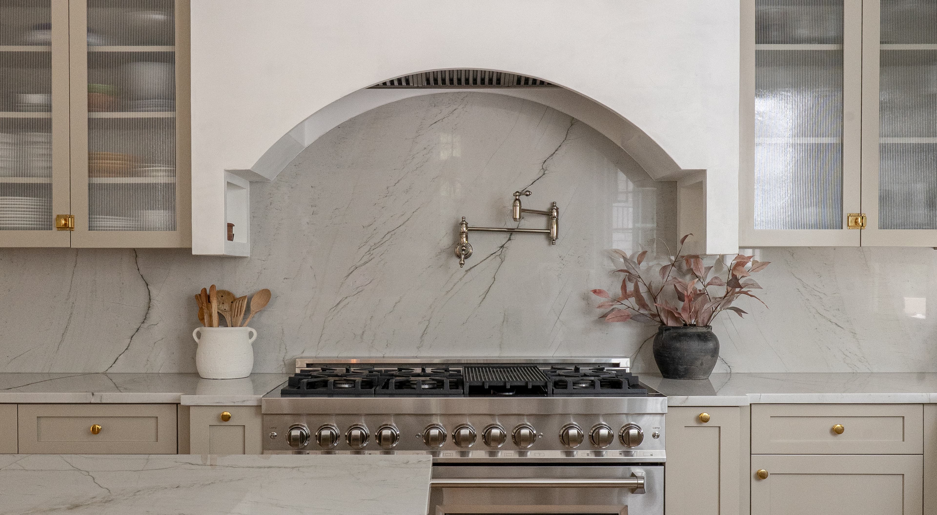 Halcyon Haus kitchen with brass fixtures and stone backsplash