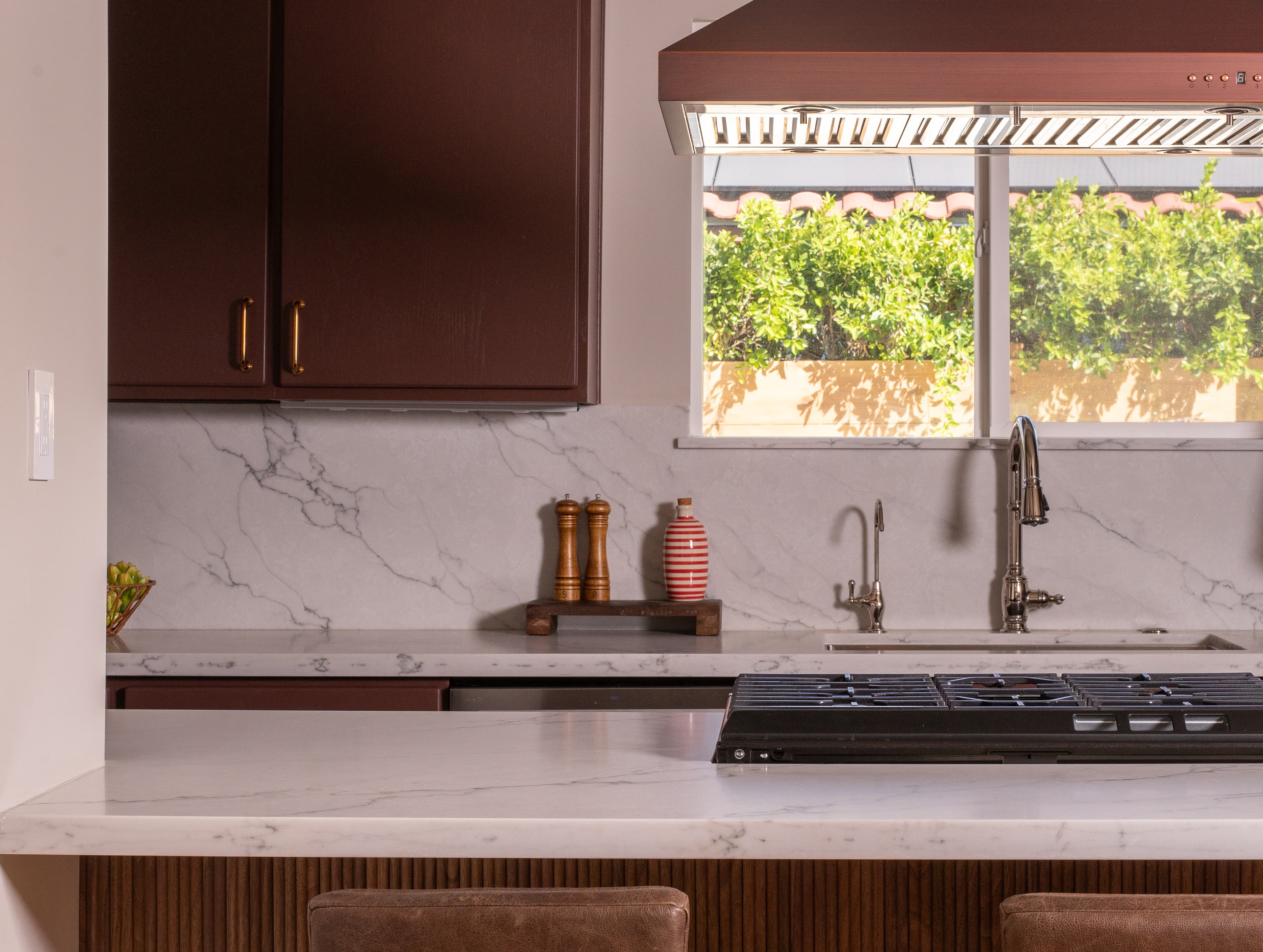 Two-toned burgundy Palm Springs kitchen designed by Halcyon Haus