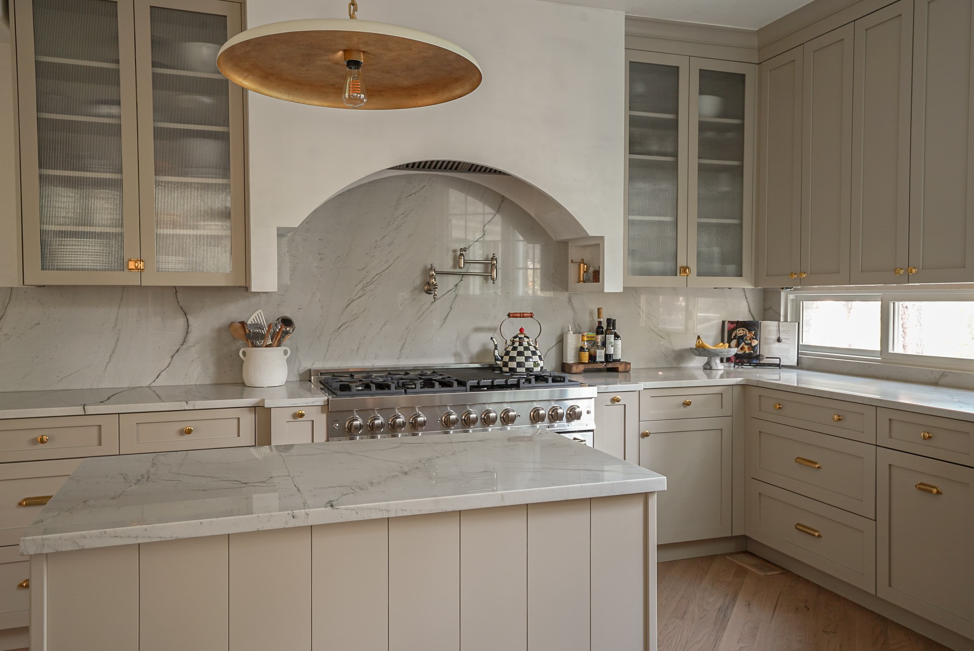 Halcyon Haus kitchen with brass fixtures and stone backsplash